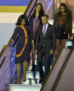 President Barack Obama exits Air Force One with first lady Michelle Obama in Narciso Rodriguez and daughters Sasha, right, and Malia at the international Buenos Aires airport, Argentina.
