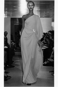 Iman wearing a Halston Original one-shoulder jersey dress in the spring 1976 show.