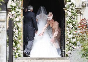 Pippa Middleton wedding The Duchess of Cambridge (in McQueen) arranges the train of Pippa Middleton