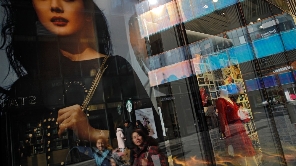 Chinese shoppers are reflected on a fashion boutique's window panels as they walk through the capital city's popular shopping mall in Beijing, . U.S. President Donald Trump expects to meet with his Chinese counterpart Xi Jinping to try to resolve a six-month trade standoff after U.S. and Chinese negotiators ended two days of talks Thursday without settling the toughest issues that divide the world's two biggest economies. The White House says the two countries made progress but "much work remains to be doneUS Trade, Beijing, China - 01 Feb 2019
