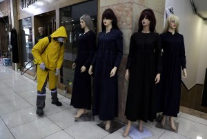 Specialists carry out the sanitization of a shopping center, in the West Bank city of Hebron.