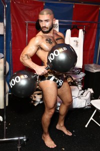 A model poses backstage in swimwear from the spring 2019 Moschino menswear collection.