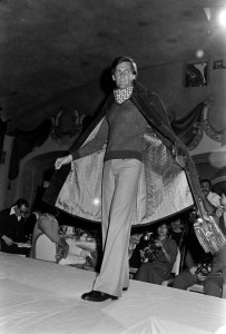 A model poses in a mink fur over Gucci's horseshoe print scarf and sweater for men during a Gucci fashion show in New York City on September 9, 1975.