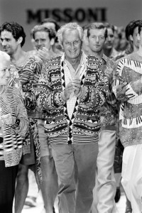 Tai and Rosita Missoni walk the Missoni Men's spring 1984 collection show finale with models.