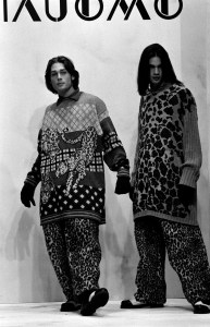 Models pose in fall 1994 Krizia Uomo animal conscious knit sweaters and faux fur animal print pants during Milan fashion week.