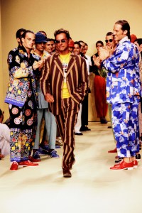 Models applaud as designer Wolfgang Joop walks the runway at show finale.