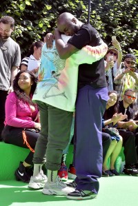 Kanye West and Virgil Abloh embrace in the front row of Abloh's first show as Artistic Director of Louis Vuitton.