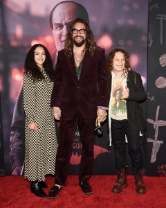 Jason Momoa, center, and his children Lola Iolani Momoa, left, and Nakoa-Wolf Manakauapo Namakaeha Momoa attend the world premiere of "The Batman" at Lincoln Center Plaza on Tuesday, March 1, 2022, in New York. (Photo by Evan Agostini/Invision/AP)