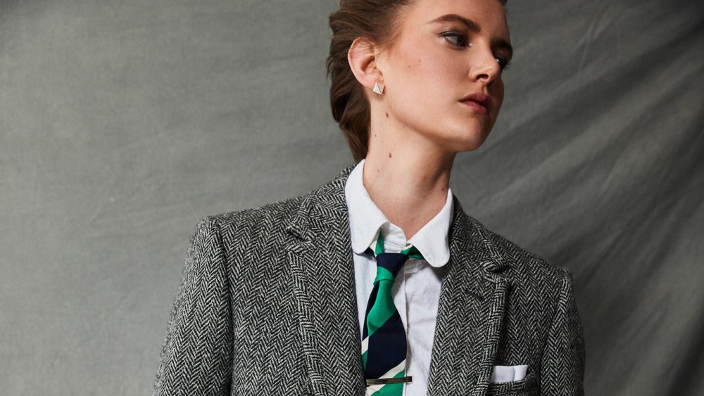 Thom Browne’s cotton oxford long-sleeve button-down shirt and Herringbone Harris Tweed’s trench, blazer, skirt and tie. Etiq earrings; Bulgari watch; David Yurman bracelet; Louis Vuitton bracelet; Vitali bracelet.