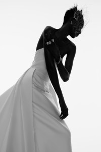 Sareh Nouri’s Italian stretch Mikado gown with detachable overskirt. Monvieve headpiece; Wempe diamond earrings, diamond chain bracelets and diamond ring; De Beers diamond rings (worn throughout).