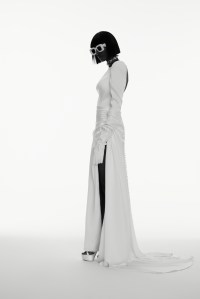 Justin Alexander’s charmeuse fit and flare gown. Stuart Weitzman platform-heeled sandals; Vera Wang Bride gloves; Loewe sunglasses; Jennifer Behr crystal headpiece as necklace.