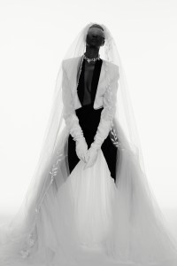 Joseph Abboud’s wool off-white dinner jacket with shawl collar black satin details and tuxedo pants and Francesca Miranda’s silk tulle detachable skirt. Justin Alexander, Sareh Nouri and Morilee by Madeline Gardner veils; Monvieve eyewear, veil and headpiece; Vera Wang Bride gloves; Jennifer Behr crown as necklace; Wempe diamond  earrings.