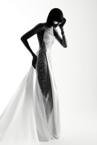 Ines Di Santo’s satin back crepe sheath with beaded tulle embellished side panel, illusion back and tails. Manolo pumps; Balenciaga sunglasses; Wempe diamond earrings, diamond chain bracelets and diamond ring; De Beers diamond rings.