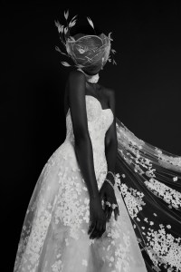 Reem Acra’s ballgown with floral embroidery over inner lace layer and embroidered cape (worn as scarf). Monvieve headpiece; Jennifer Behr earring; Wempe diamond earrings, diamond chain bracelets and diamond ring; De Beers diamond rings.