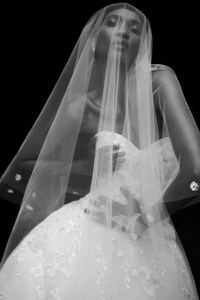 Rami Al Ali’s embellished polyester lace, silk organza, nylon tulle and polyester lined gown. Sareh Nouri veil; Wempe diamond earrings, diamond chain bracelets and diamond ring; De Beers diamond rings.