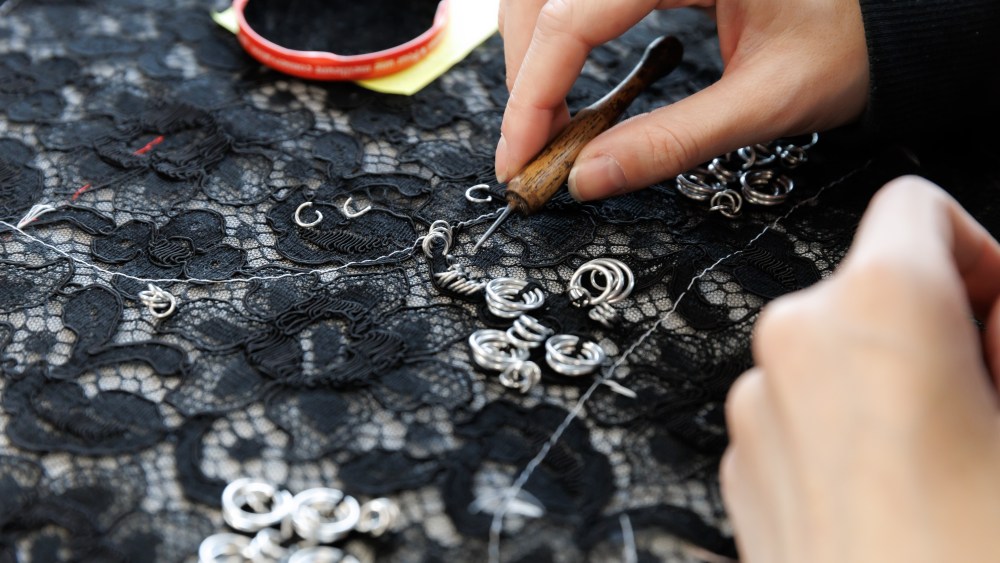 Black lace is embellished with silver metal rings at Atelier Montex