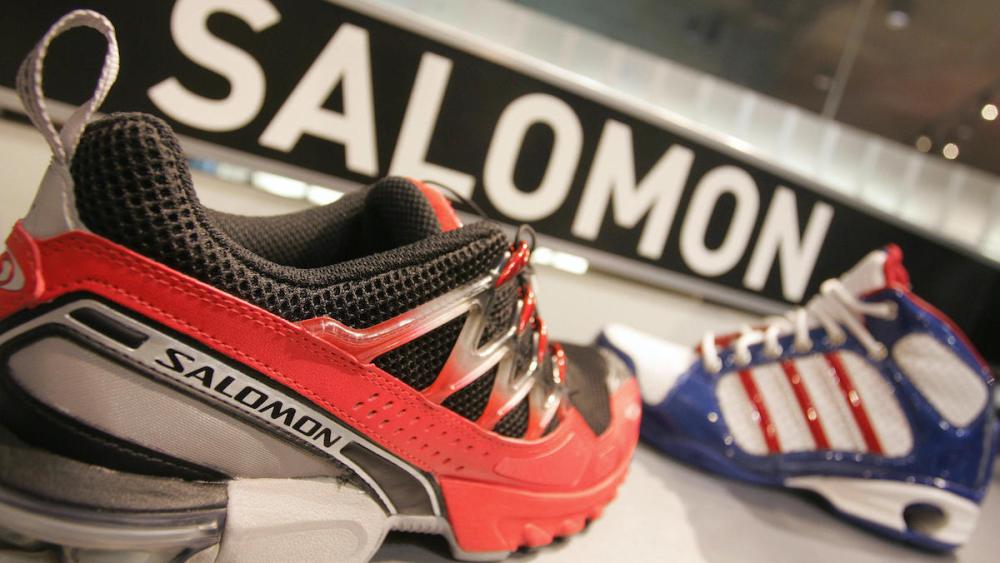 HERZOGENAURACH, Germany:  Sport shoes of the brands Adidas (R) and Salomon are seen in a shop 03 May 2005 in Herzogenaurach, southern Germany. Adidas-Salomon, the German maker of sportswear and equipment, annuonced on 02 May 2005 that it had agreed to sell its French subsidiary Salomon to Finnish firm Amer Sports Corporation in a deal that valued Salomon at around 485 million euros (621 million dollars). AFP PHOTO   DDP/OLIVER LANG     GERMANY OUT   Ein Sportschuh der Marke Salomon steht am Dienstag (03.05.05) in Herzogenaurach vor einem Schuh von adidas. Am Mittwoch (03.05.05) hat der Sportartikelhersteller seine Hauptversammlung. Foto: Oliver Lang/ddp  (Photo credit should read OLIVER LANG/DDP/AFP via Getty Images)