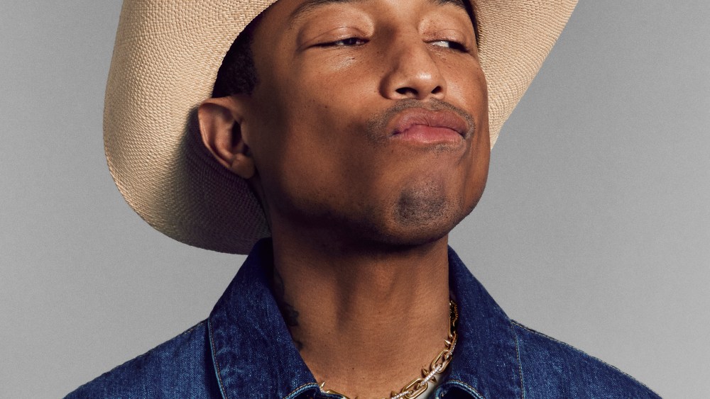 Pharrell Williams wearing a cowboy hat and denim shirt
