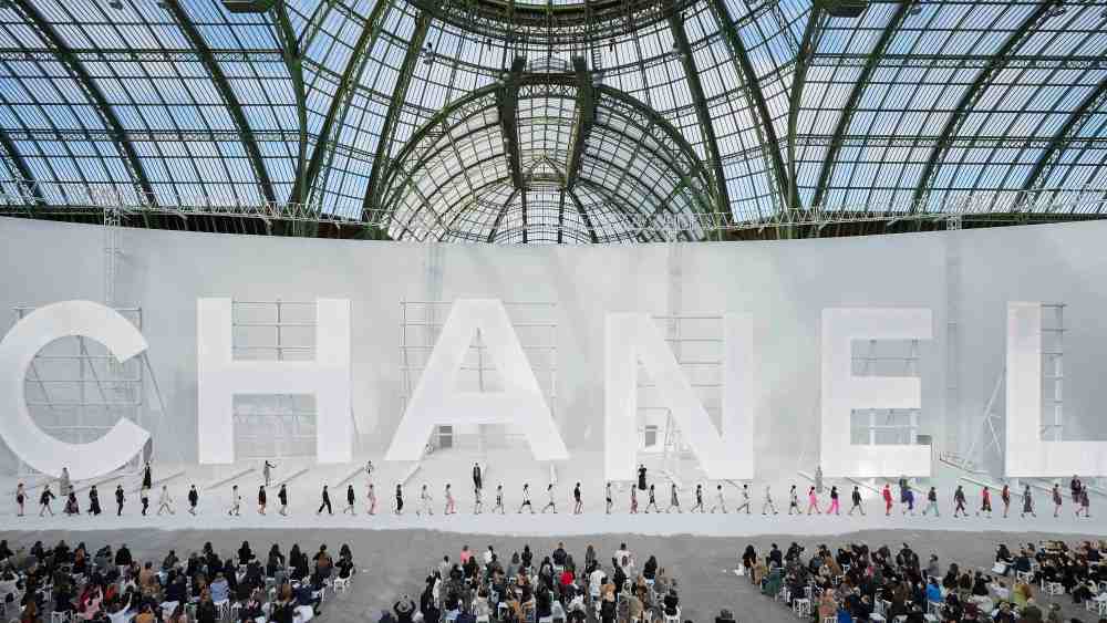 The finale of Chanel's spring 2021 ready-to-wear collection featured a set with giant letters spelling out the brand's name under the glass and steel roof of the Grand Palais in Paris.