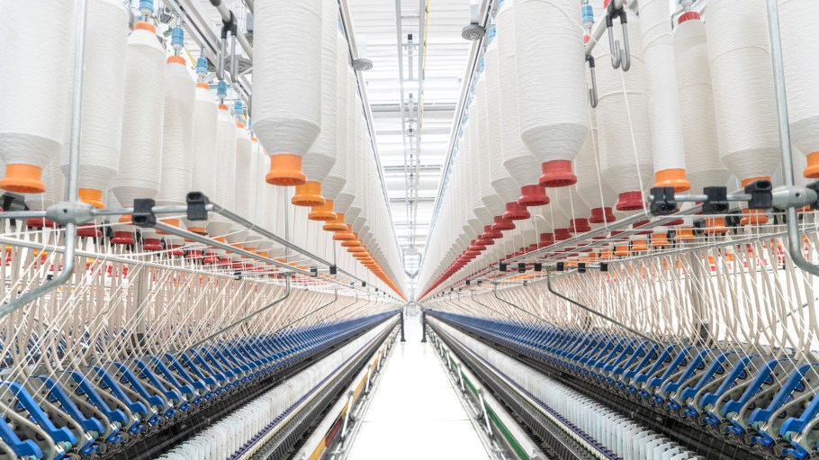 Spools of yarn on a spinning machine seen at the wool manufacturing facility