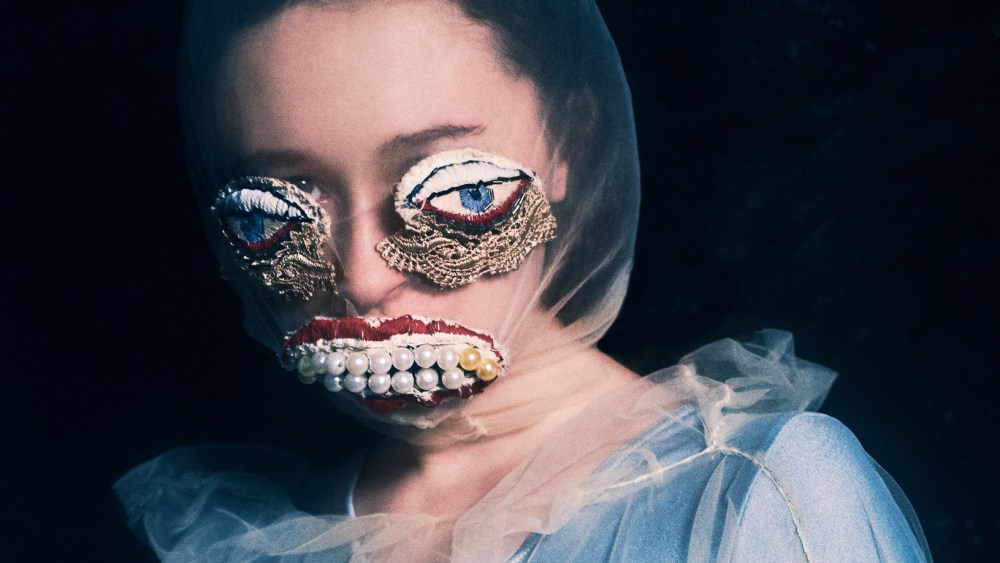 The artist Alisa Gorshenina wearing artificial eyes and a jeweled mouth.