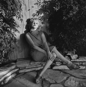 American actress Marilyn Monroe (1926 - 1962) sits in shadow against a garden fence, 1954. (Photo by Hulton Archive/Getty Images)