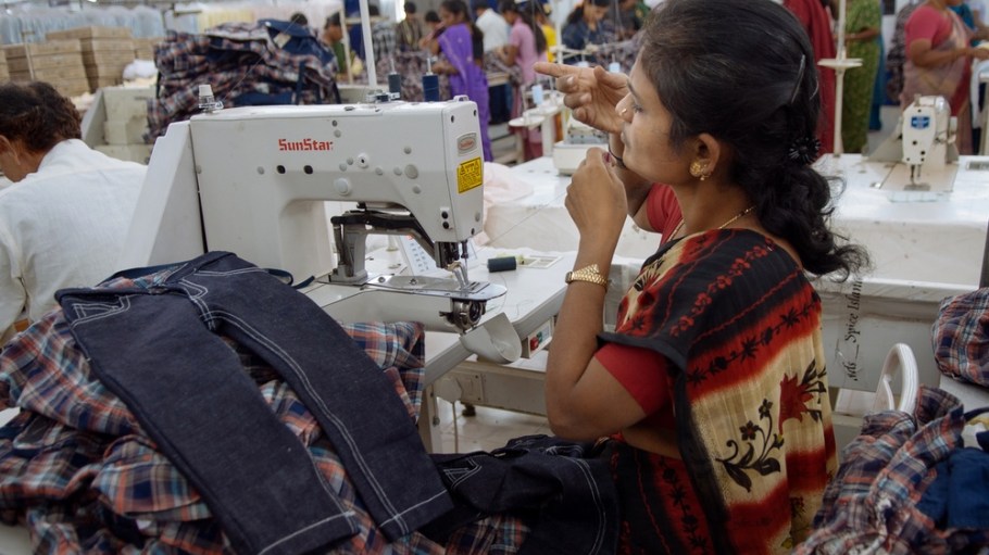 A seamstress making clothing at a garment factory in Bangalore. Many of the workers emigrate from poor regions of the country, making clothes to be sold in the United States.  (Photo by Jodi Hilton/NurPhoto)